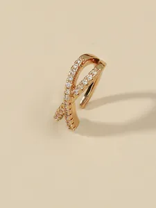 Detailed view of a gold-plated criss-cross ear clip with sparkling zircon inlay