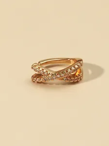 Detailed macro view showing the sparkling zircon inlay and crossover gold-plated ear cuff