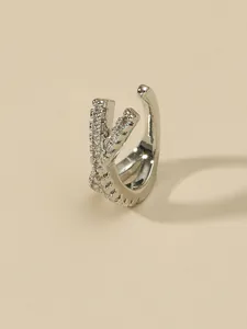Detailed macro view of a silver-plated cross zircon ear cuff for non-pierced ears