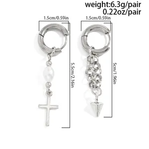 Detailed view of asymmetric silver earrings with pearl cross and chain spike charms