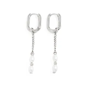 Detail of silver-tone U-shaped earrings featuring delicate chain tassels and pearls