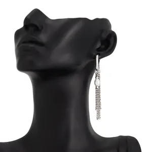 Detail view of silver U-shaped hoop earring with pearl and long chain tassels