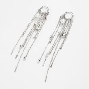 Macro shot of silver multi-strand chain tassel earrings featuring elegant white pearls