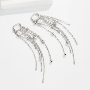 Detailed view of silver multi-layer chain tassel earrings with white pearls and heart charms