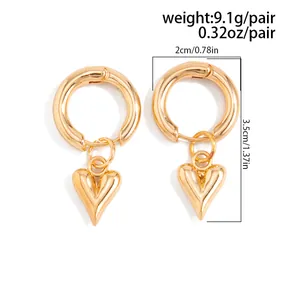 Detail of gold-tone heart-shaped pendant hoop earrings with size measurements