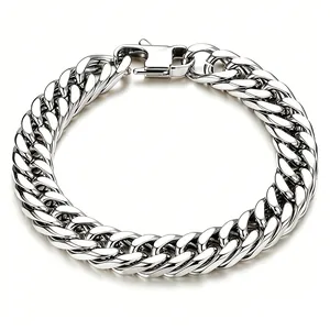 Macro view of a chunky polished titanium steel Cuban link chain with a lobster clasp.