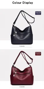 Détail du motif trèfle à quatre feuilles embossé sur sacs en cuir bleu marine et bordeaux