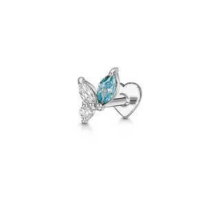 Detail view of marquise-cut blue stone and heart-shaped back on silver cartilage earring.