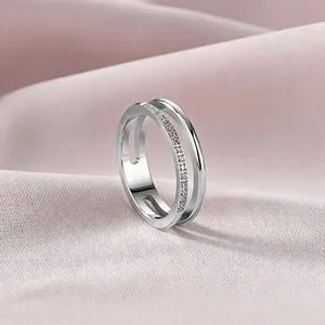 Macro view of a minimalist double-layer titanium steel ring with delicate pavé stones