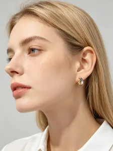 Model wearing gold-plated multicolor baguette zircon hoop earrings in S925 silver.
