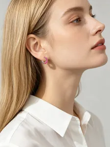 Close-up detail of S925 silver hoop earring with square pink zircon stones on model