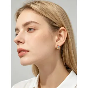 Gold-plated hoop earrings with multicolored rectangular zircon stones shown on a model