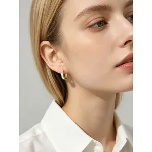 Elegant s925 silver hoop earrings featuring baguette-cut zircon stones worn by a model