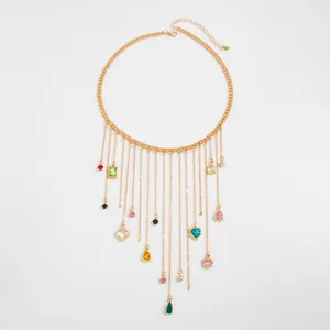 Detailed view of a gold fringe necklace featuring vibrant multi-colored crystal charms