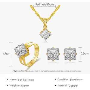 Detailed view of gold-plated copper jewelry set with square clear zirconia stones