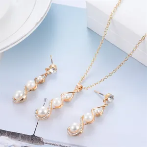 Detailed view of gold jewelry set featuring elegant white pearls and zircon crystals.