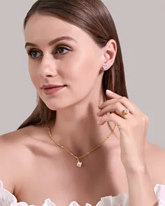 Elegant square-cut cubic zirconia jewelry set with gold necklace, earrings and ring on model.