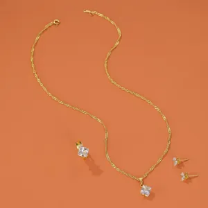 Detail view of gold jewelry set with square zircon pendant necklace earrings ring