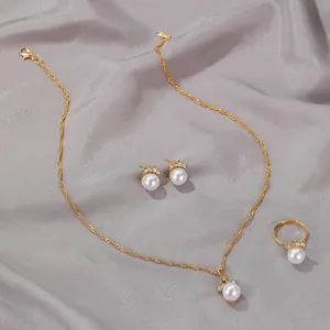 Detailed shot of gold pearl and zircon jewelry set with necklace, earrings, and ring