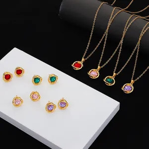 Variety of gold-plated necklaces and stud earrings with colorful circular crystals