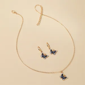 Elegant gold-tone necklace and earring jewelry set featuring delicate blue butterfly charms