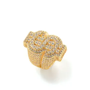 Detailed macro view of gold plated hiphop iced out dollar sign ring with sparkling crystals