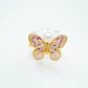 Close-up of Monet-style butterfly pendant with natural freshwater pearl and gold plating
