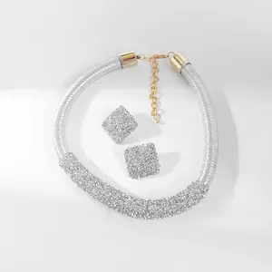 Detailaufnahme eines eleganten silbernen Brauthalsketten- und Strassohrring-Sets