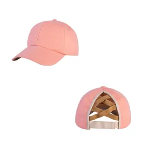 Detailed view of soft peach knitted baseball cap featuring a unique cross ponytail opening
