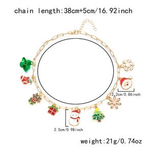 Detailed view of gold Christmas charm necklace with Santa, reindeer and snowflake pendants