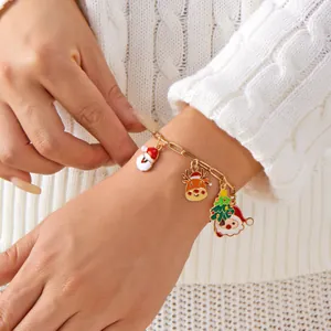 Festive Christmas charm bracelet featuring Santa Claus, reindeer, and tree on wrist