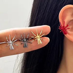 Macro view of gothic spider ear cuffs in various metallic finishes and a bold red color