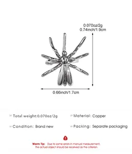 Detail view of Halloween silver spider ear clip showing dimensions 1.9cm by 1.7cm in copper