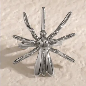 Detailed view of a silver-toned spider-shaped non-pierced gothic ear cuff for Halloween.
