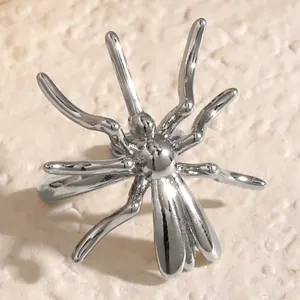 Macro detail of a silver-toned spider ear cuff for non-pierced ears, gothic style