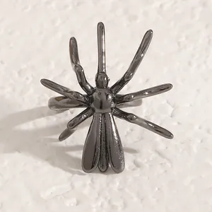 Close-up of a black spider ear cuff with a glossy metallic finish for Halloween jewelry