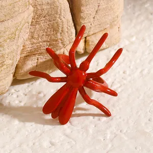 Detailed close-up of a glossy red spider ear cuff for Halloween Gothic style
