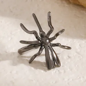 Macro detail of dark gunmetal spider ear cuff for Halloween gothic jewelry styling.