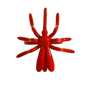 Detail view of a glossy red spider ear cuff designed for Halloween jewelry styles