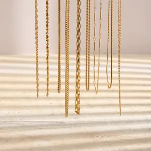 Detail shot of multiple 18K gold plated titanium steel chain necklaces hanging vertically.