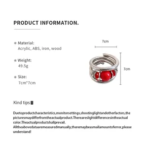 Detailed view of multi-layer wrap bracelet with red acrylic beads and silver coils
