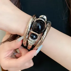 Detail view of a vintage multi-layered wrap bracelet with large black acrylic beads
