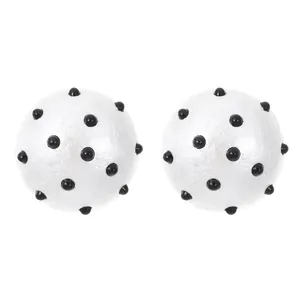 Detailed close-up view of black and white polka dot spherical acrylic earrings for women