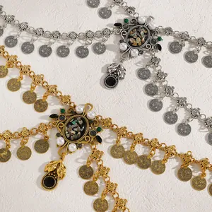 Detailed view of vintage ethnic gold and silver waist chains with coins and pearls