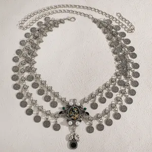 Detailed view of ethnic silver waist chain with coins and colorful shell pearl pendant