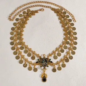 Detailed view of vintage gold coin waist chain with iridescent shell and pearl pendant