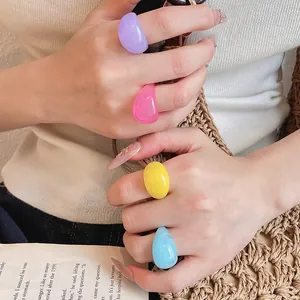 Close-up of colorful marbled resin rings in purple, pink, yellow, and blue on a model