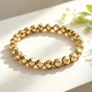 Close-up view of a faceted pyrite beaded bracelet showing its metallic golden texture.