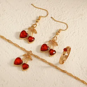 Exquisite close-up of red heart cherry jewelry set including necklace, earrings and ring