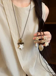 Detailed view of a retro ethnic style long necklace with star and teardrop pendants